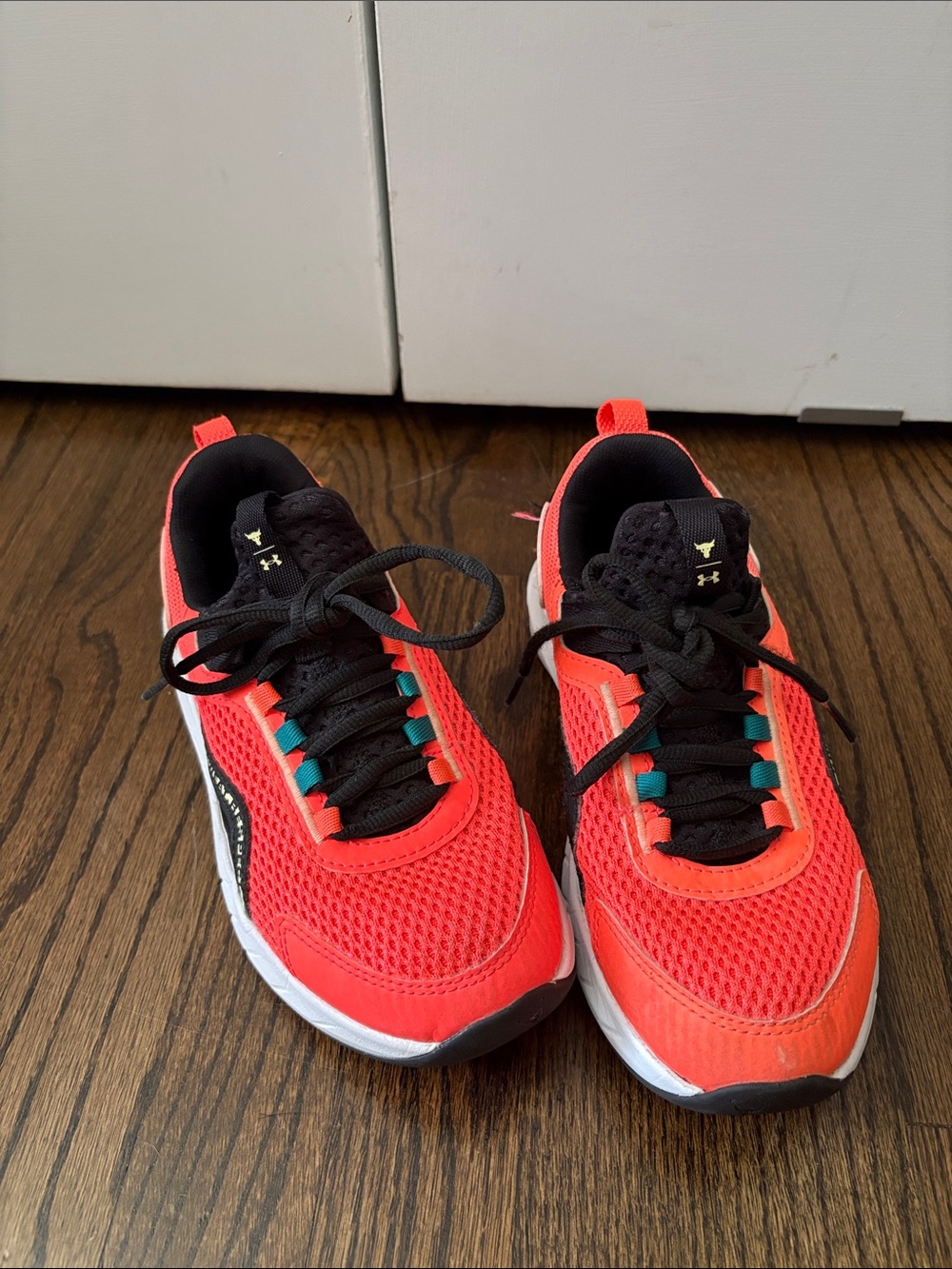 Under Armour Kids' Neon Orange and Black Athletic Sneakers with Teal Accents
